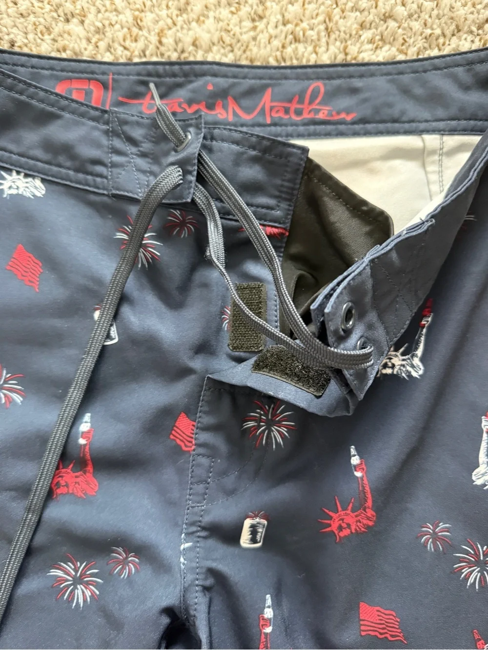 Travis Mathew Navy Swim Shorts with Red & White Liberty Icons